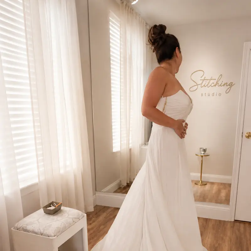 Bride in a chiffon A-line wedding gown during a fitting at the Stitching Studio showroom